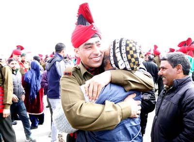 A passout hugs his father at J&K Light Infantry Regiment in Srinagar on Monday. -Excelsior/Shakeel