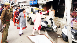 JMC officers during a drive to remove hoardings and encroachments in Jammu on Tuesday.