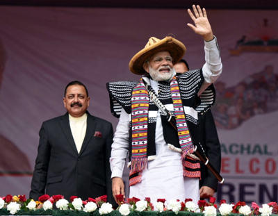 Prime Minister Narendra Modi waiving at the cheering crowd at Itanagar, Arunachal Pradesh on Thursday. Also seen is DoNER Minister Dr Jitendra Singh.
