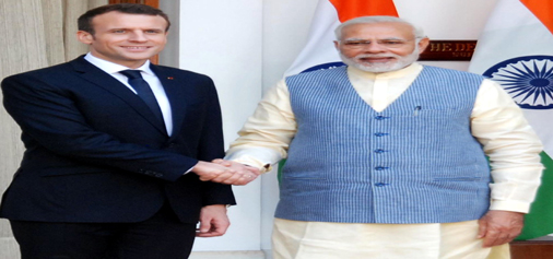 French President Emmanuel Macron being welcomed by Prime Minister Narendra Modi at Hyderabad House in New Delhi on Saturday. (UNI)