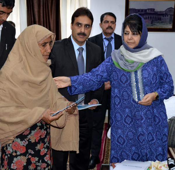 Chief Minister Mehbooba Mufti handing over cash relief to border shelling victim’s kin in Poonch on Monday.