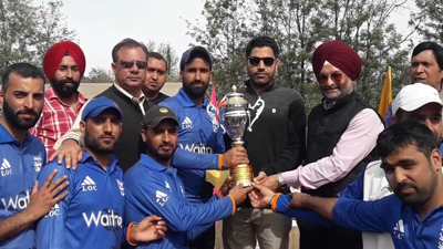Jubilant players of LoC Club Poonch posing for a group photograph while receiving trophy.