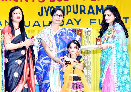 Child being felicitated by the dignitaries during Annual Day celebration at Play School Jyotipuram.