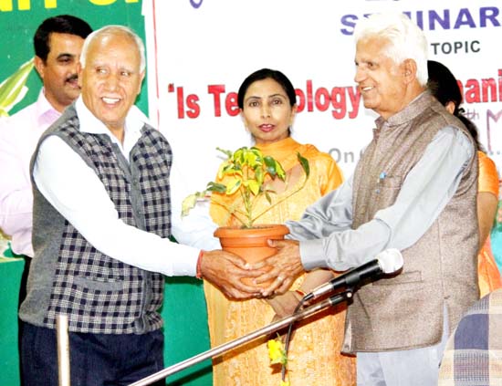 A plant being presented to the chief guest as a token of gratitude during a seminar at GMCEJ.