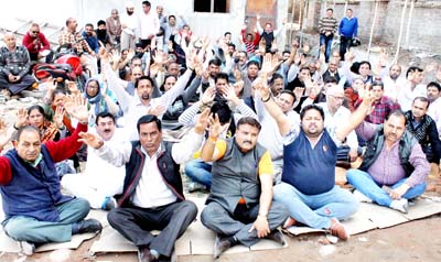 Ration dealers sitting on protest dharna outside CAPD office in Jammu on Monday. -Excelsior/Rakesh