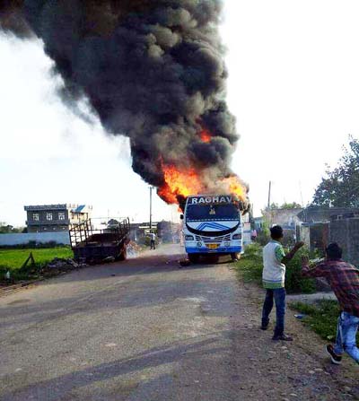 A bus carrying baratis in flames at Dolian Jattan in Hiranagar on Tuesday. —Excelsior/Madan