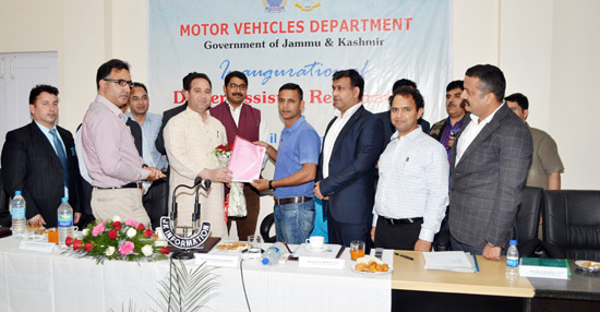 Transport Minister, Sunil Sharma, handing over temporary registration number to a customer during inauguration of Dealer Assisted Registration.