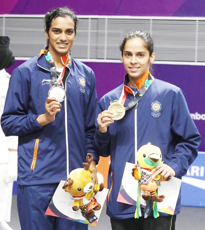 India’s Star Shuttlers P V Sindhu and Saina Nehwal displaying medals at Jakarta.