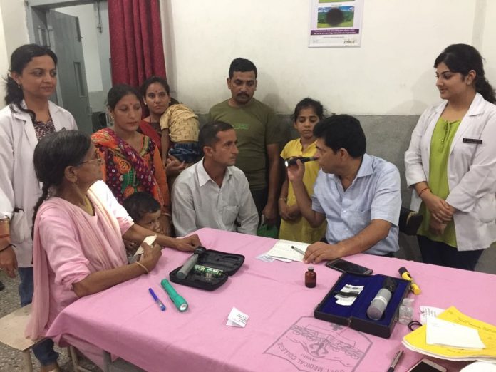 HoD Ophthalmology GMC Jammu Dr Dinesh Gupta examining a patient before registration for eye donation in GMC Jammu on Monday.