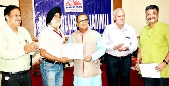 Speaker Legislative Assembly Dr Nirmal Singh giving away certificate in Press Club Jammu on Friday.