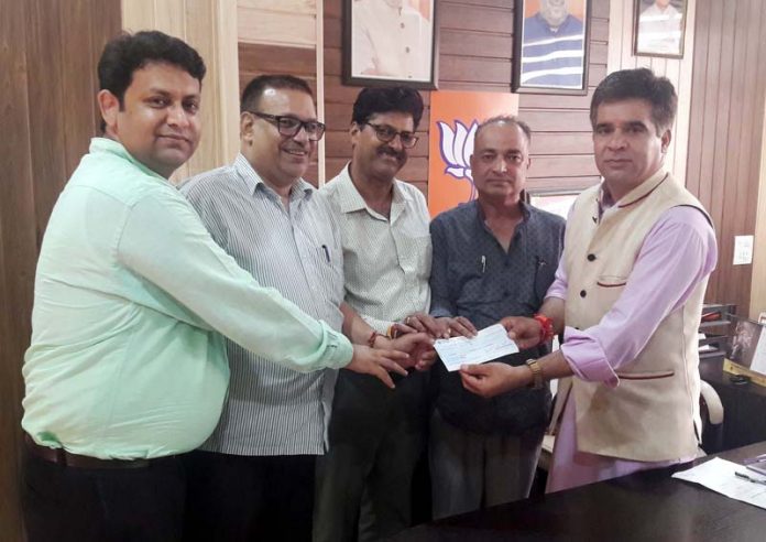 HPS members presenting a cheque to BJP State president, Ravinder Raina.