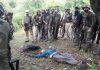 Security personnel stand around the body of slain militant at village Dirthi in Kakryal area on Thursday. —Excelsior/Rakesh