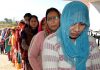 Women queue up outside a polling station in Udhampur on Saturday.