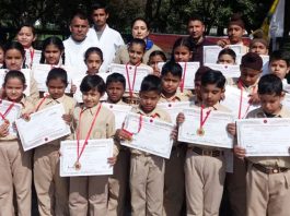 Children displaying certificates after qualifying Belt Grading Test in Jammu.