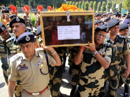 DG BSF R K Mishra lends a shoulder to the mortal remains of BSF Inspector T Alex Lalminlum at BSF Headquarters at Paloura on Tuesday.