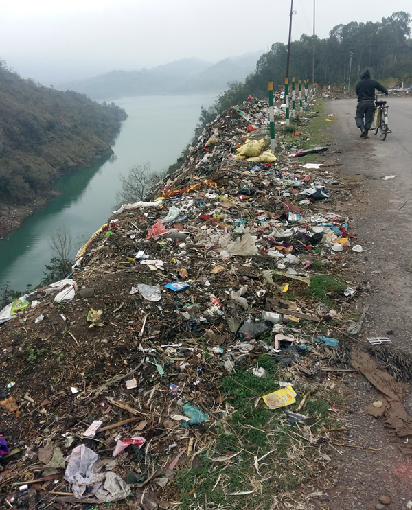 Heaps of garbage along Basohli-Bani Road polluting environment.