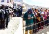 Long queues of voters in Kargil (left) and Leh (right) on Monday. -Excelsior pics by Basharat Ladakhi & Morup Stanzin