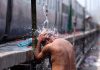 A man takes bath at Railway Station to cool himself on a hot summer afternoon in Jammu on Wednesday. —Excelsior/Rakesh