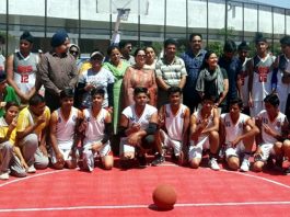 Participating teams posing with DYSSO Jammu, Chanchal Kour at Basketball court, MA Stadium in Jammu on Thursday.