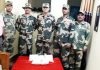 BSF officials showing seized heroin.