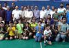 Young shuttlers posing along with dignitaries and officials in Jammu on Monday.