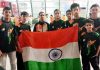 Soham Sharma of GD Goenka Public School, Jammu holding Indian flag along with other players.