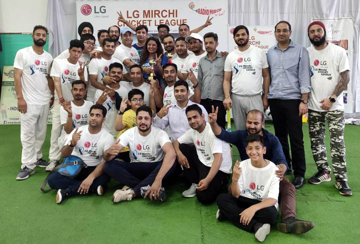 Players of jubilant Media XI Cricket Club posing for a group photograph after registering win in LG Mirchi Cricket League 2019 at KCSC in Jammu.