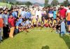 Teams posing for a group photograph during inaugural match of Poonch Hockey League in Poonch on Monday.