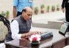 Defence Minister Rajnath Singh signing the visitors' book after paying homage to martyrs on the occasion of the 20th anniversary of Kargil Vijay Diwas at the National War Memorial in New Delhi on Friday.