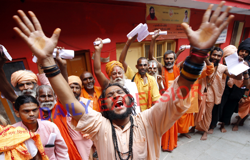 Sadhus singing bhajans and dancing in front of a registration counter at Jammu on Monday. -Excelsior/Rakesh