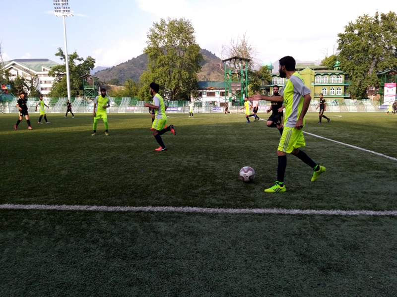 Footballers in action during a match of State Football League Tournament in Srinagar.