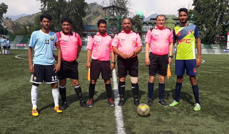 Footballers posing for a group photograph during JKFA Annual League Football tournament in Srinagar.