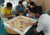 Players showing keen interest during a carrom match of District Level Inter School Tournament in Jammu.