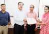Dr S D Singh Jamwal, Director, SKPA Udhampur, presenting certificate of participation to a woman police official.
