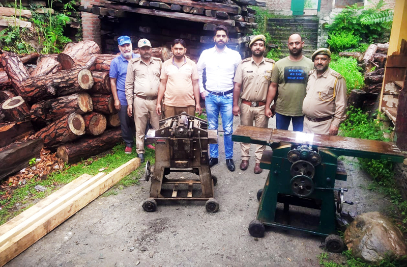 Forest Department officials showing seized illegal planer machines at Bhaderwah on Monday. -Excelsior/Tilak Raj