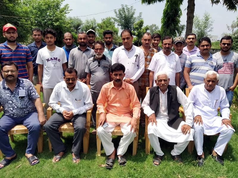 Arun Sharma with BJP workers in a meeting at Vijaypur on Sunday.