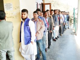 Panchayat members wait to cast their vote in Ramban on Thursday.