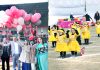Dignitaries releasing balloons while children presenting a colourful dance item during Mega Sports Carnival by MMI Pre-School Jammu on Sunday. -Excelsior/Rakesh