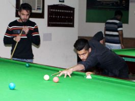 Cueist aiming at target during Sub Junior Snooker Championship at Billiards Hall, MA Stadium in Jammu. — Excelsior/Rakesh