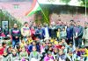 Provincial President NC Devender Singh Rana holding National Flag while posing with children during Annual Day celebration at Motherland Public School in Jammu.