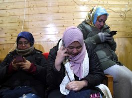 Malaysian tourists turning emotional after they called their families using internet access at media centre in Srinagar. —Excelsior/Shakeel