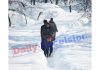 People walk through heavy snowfall at Tangmarg in Kashmir. —Excelsior/Aabid Nabi