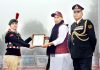 Defence Minister Rajnath Singh presenting Raksha Mantri Padak and Commendation Cards to brave NCC cadets during his visit to NCC Republic Day Camp in New Delhi on Wednesday. (UNI)