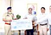 Director General of Police, Dilbag Singh presenting a cheque of Rs 9.47 cr to the Lieutenant Governor, Girish Chandra Murmu towards J&K Relief Fund.