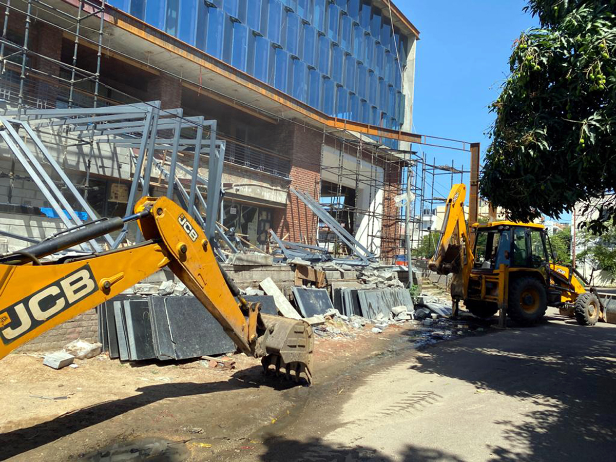JCB machines demolishing a violative portion of the commercial building in Channi Himmat area of Jammu.