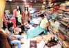 Masked customers in a garment shop at Lal Chowk in Srinagar on Monday.(UNI)