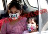 Children travelling in a car wearing masks in Srinagar on Sunday. — Excelsior/Shakeel