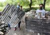 Residents show tin sheets damaged in shelling in Bhag Bella village in Tangdhar area of north Kashmir. —Excelsior/Aabid Nabi