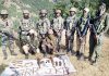 Security forces along with recovered arms and ammunition in Rajouri area on Friday.