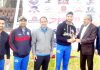 Former Ranji Trophy skipper Ashwani Gupta presenting man of the match award to Praful Dhar at MA Stadium in Jammu.